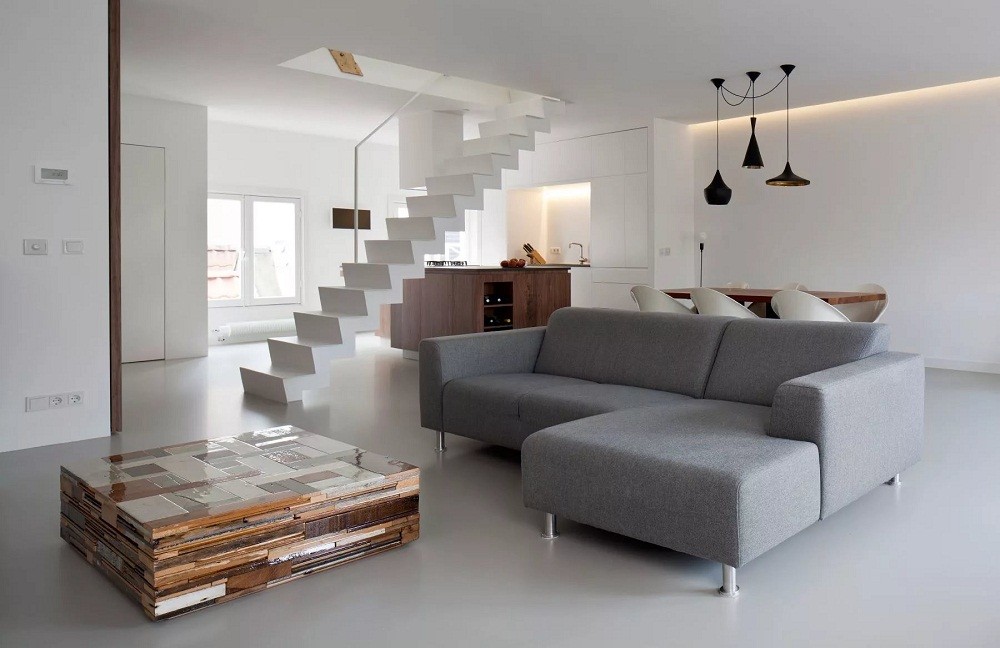 Серый угловой диван в двухуровневой квартире-студии