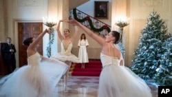 First lady Melania Trump watches dancers perform as part of the opening of the White House holiday season.