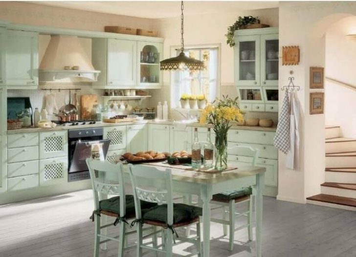 Wooden dining table, white wardrobes and chairs - kitchen furniture in country style
