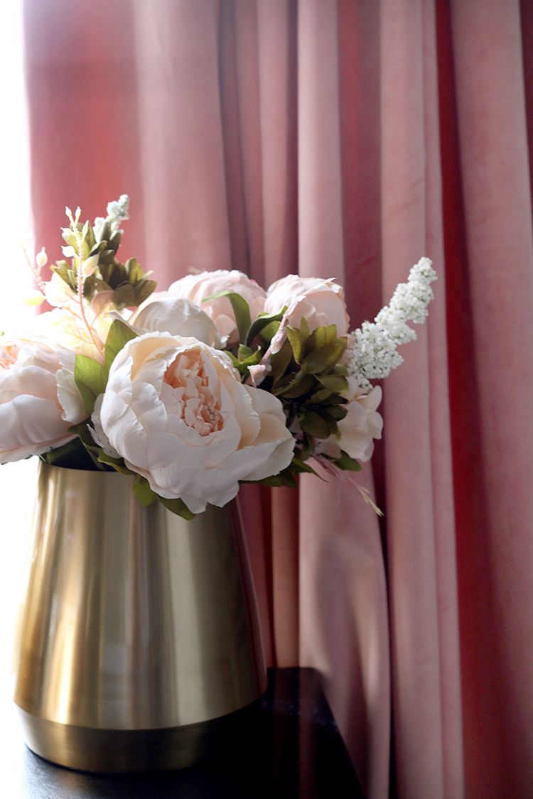 faux peonies in gold vase with blush pink curtains