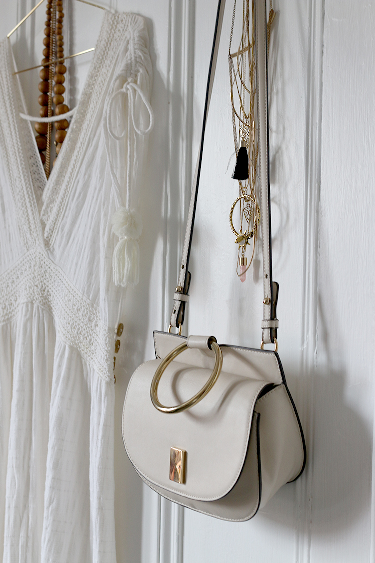 dressing room with white dress and bag from Mango