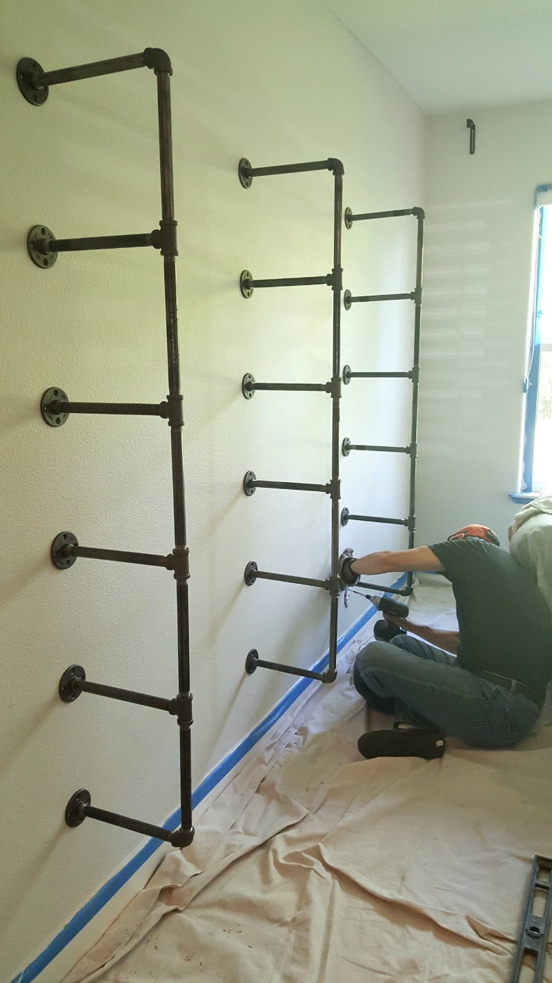 Three pipe braces anchored into studs insures a secure shelf